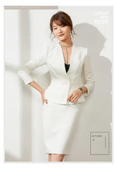 Woman in a white outfit posing against a light gray background