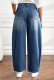 Back view of medium wash barrel leg jeans with back patch pockets
