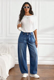 Blue high waist curved seam barrel leg jeans with a white tee and sneakers, front view