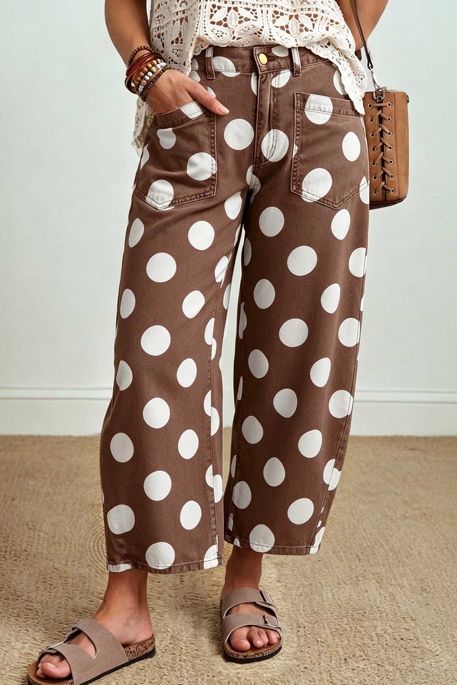 Brown polka dot barrel leg ankle jeans with a cream crochet top and slide sandals