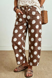 Side view of brown barrel leg jeans with large white polka dots