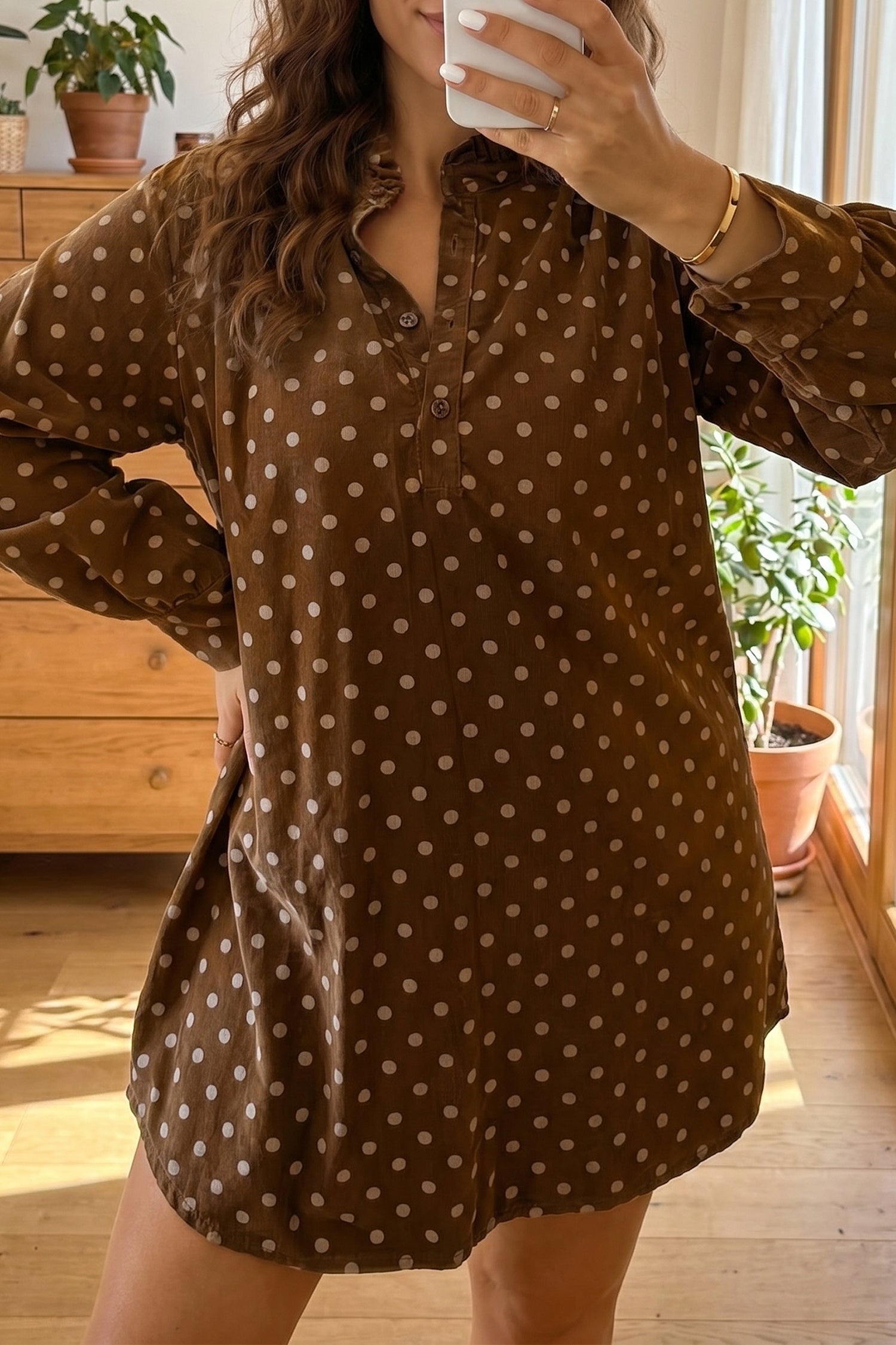 Woman wearing brown polka dot ruffle collar long sleeve shift dress, mirror selfie