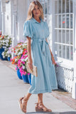 Woman wearing a light blue dress with a floral background