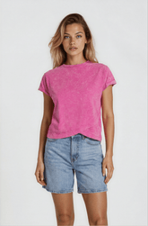 Woman wearing a pink t-shirt and blue shorts on a white background