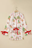 White Christmas pajama set with red trim and bow details on hanger.