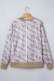Beige-white-purple camo zip-up jacket with tan ribbed cuffs and hem on hanger.