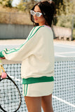 Woman in a tennis outfit holding a racket on a tennis court
