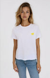 Woman wearing a white t-shirt with a yellow heart design on a plain background