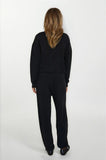 Person wearing a black outfit on a white background