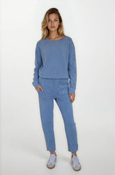 Woman wearing a blue outfit with a plain background