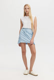 Woman wearing a light blue skirt and white top on a white background