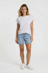 Woman wearing a white t-shirt and denim shorts on a white background