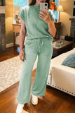 Person wearing a green outfit in a living room setting