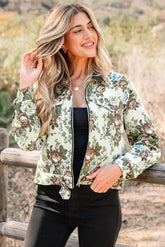 Woman wearing a floral jacket standing outdoors with a blurred natural background