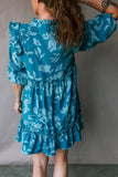Person wearing a blue floral dress against a plain background