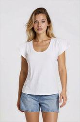 Woman wearing a white t-shirt and denim shorts on a plain background