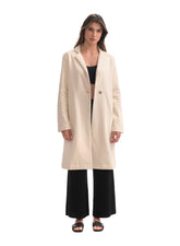 Woman wearing a beige coat on a white background
