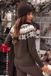 Woman in a brown beanie and Fair Isle sweater, viewed from behind in a festive shop.