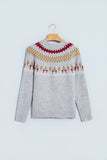 Light gray Fair Isle knit sweater with red, beige, and white pattern on hanger.