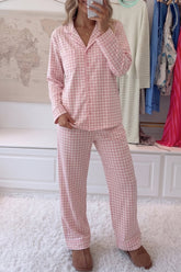 Woman in pink-white gingham pajamas with button-up shirt and wide-leg pants.