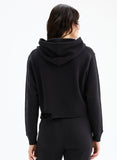 Person wearing a black hoodie from behind on a white background
