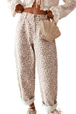 High rise gray leopard jeans styled with cream knit cardigan and woven bag