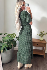 Side view of the green plaid maxi dress with puff sleeves and ruffle hem