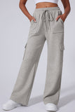 Gray cargo pants worn by a person on a light gray background