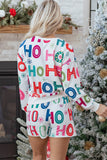 Person wearing a festive pajama set with 'HO HO HO' text in a Christmas setting.