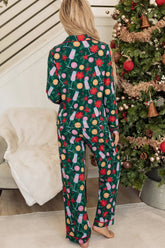 Woman in green holiday pajamas with colorful ornaments and snowflake print.