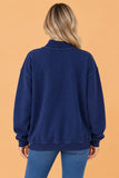 Back view of navy oversized mock neck sweatshirt with ribbed hem