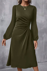 Woman in jungle green ruched front long sleeve midi dress, front view