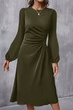 Woman in jungle green ruched front long sleeve midi dress, front view