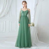 Green evening gown with floral lace top in a white room
