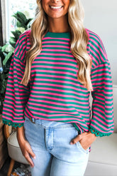 Woman wearing a striped shirt with long sleeves in a casual setting