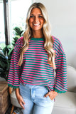 Woman wearing a striped sweater and jeans indoors
