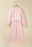 Pink crop top and drawstring wide leg pants set on a hanger, front view