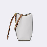 White handbag with brown strap on a light gray background