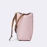Pink handbag with brown strap on a light gray background