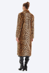 Person wearing a leopard print coat on a white background