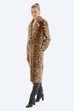 Woman wearing a leopard print coat on a white background