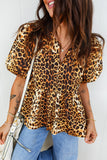 Woman wearing a leopard print blouse with a white background