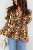 Woman wearing a leopard print blouse and blue jeans against a white background