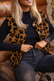 Woman in brown-black leopard faux-fur vest, black top, and dark gray jeans.