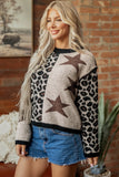 Woman in fuzzy leopard-print sweater with brown stars and black trim, paired with denim shorts.