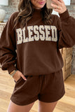 Woman in coffee BLESSED letter patch sweatshirt and shorts set, mirror selfie