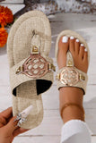 Beige sandals with decorative straps on a light wooden floor.