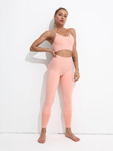 Woman wearing a pink athletic outfit against a white background