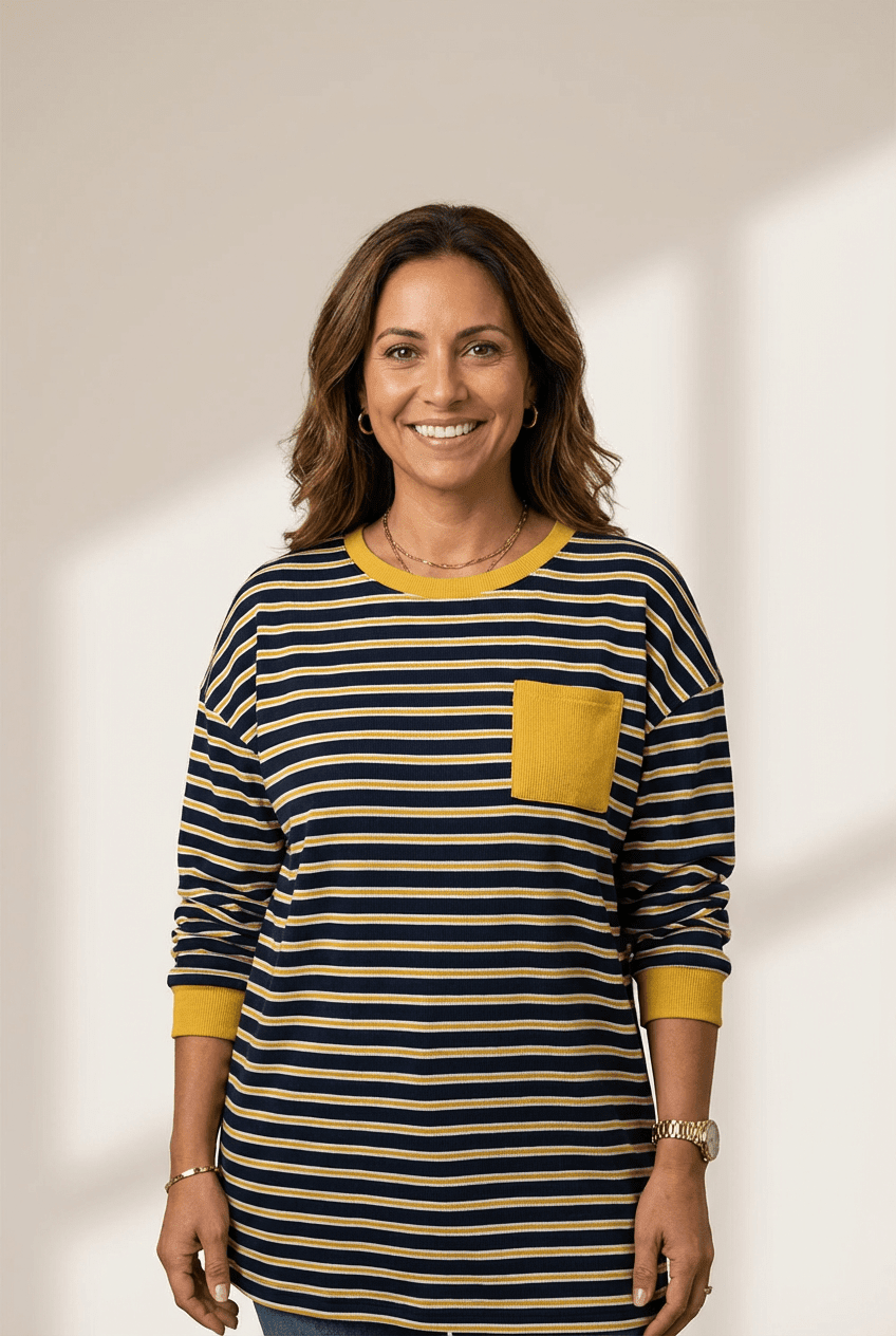 Woman wearing a striped shirt with a yellow pocket on a plain background