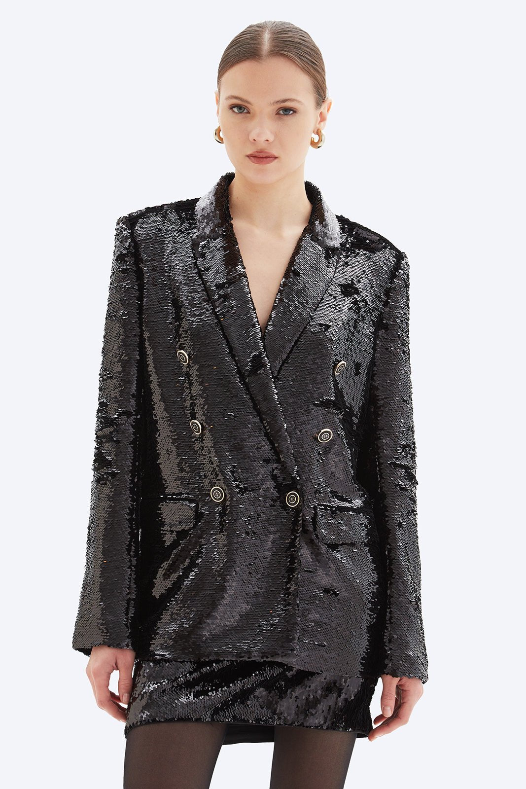 Black sequin blazer worn by a model on a white background